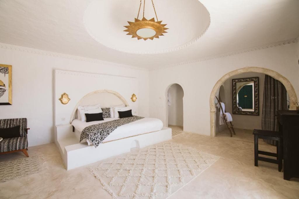 White vaulted bedroom with an alcove