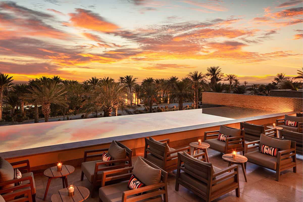 Terrace bar among the palms at sunset