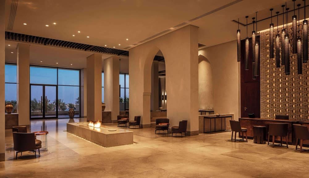 Hotel lobby with arched windows onto the sea
